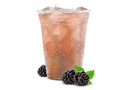 Blackberry sangria mocktail made with ginger ale, served over ice in a clear cup