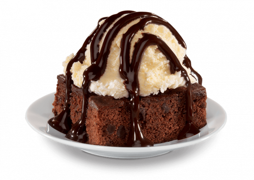 ice cream scoop on brownie with chocolate sauce